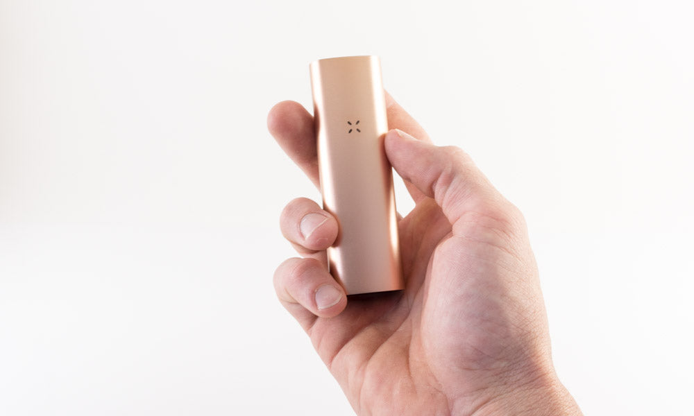 Pax 3 rose gold in hand with white background